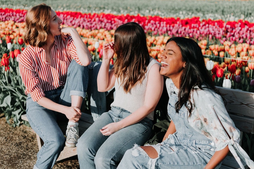 Friends sharing a laugh in the park